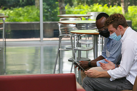 Two people looking at a computer