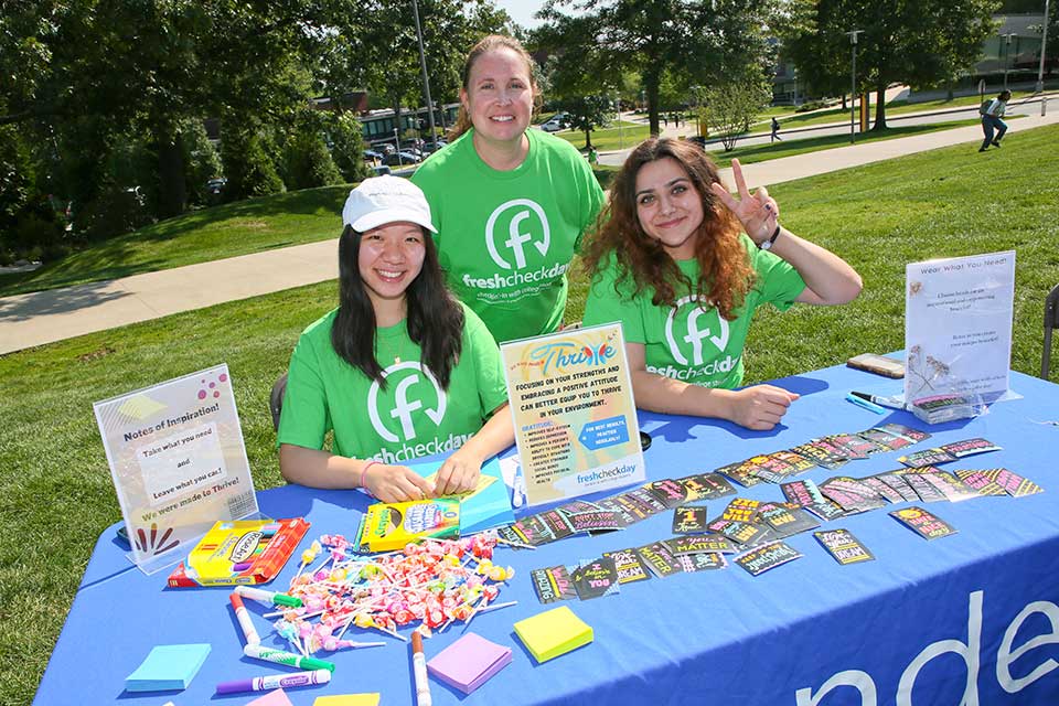 Three volunteers at the Thrive booth