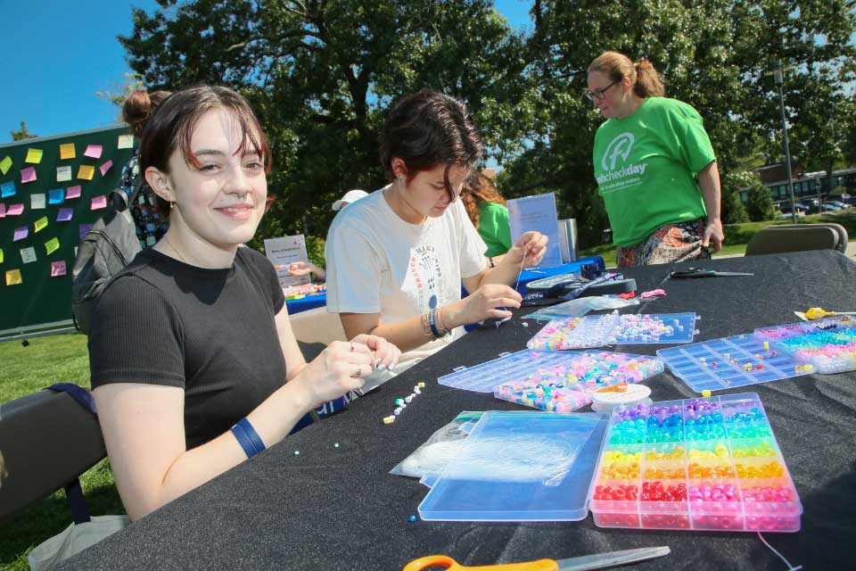 Students do arts and crafts at the Thrive booth