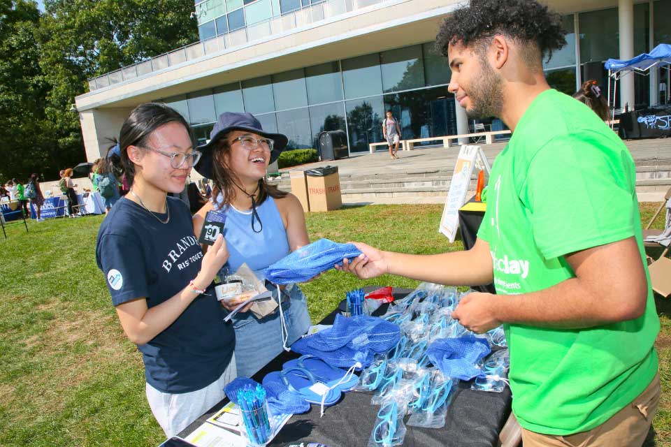 A volunteer hands t-shirts to other volunteers