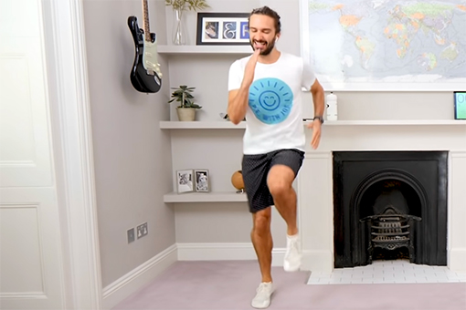 Image of man running in place in a white living room