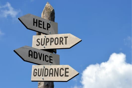 Image of a signpost with multiple signs saying "Help" "Support" "Advice" and "Guidance"
