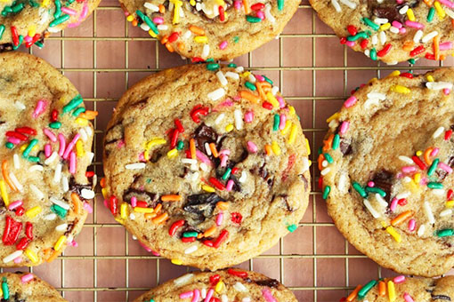 Close up of chocolate chip cookies with rainbow sprinkles on them
