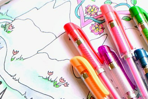 Image of a hand drawn coloring page with orange, red, purple, pink, and blue pens