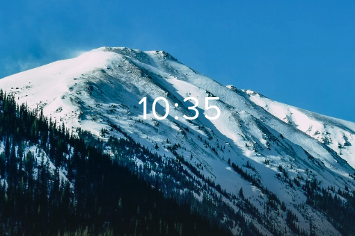 A snowcapped mountain against a blue sky