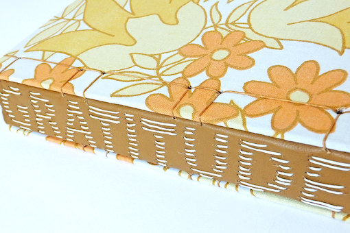 A close up image of a journal with "gratitude" written on the spine