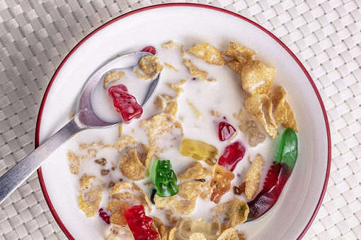 A bowl of cereal with gummy bears. 