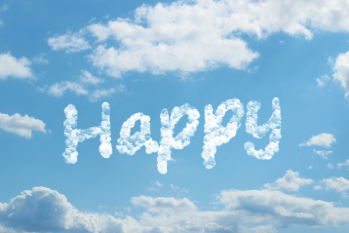 the word "happy" written in clouds against a blue sky