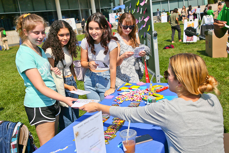 Students pick up papers at a table at Fresh Check Day