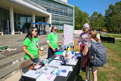 Students stop by a table during Fresh Check Day