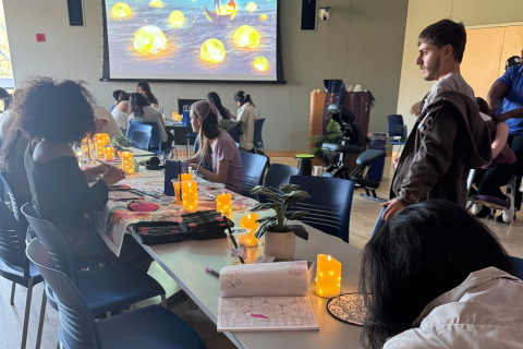 Students coloring amid candle light