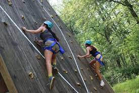 girls climbing on wall