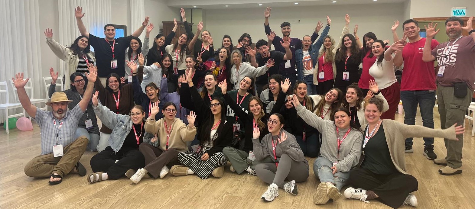 group of young people waving
