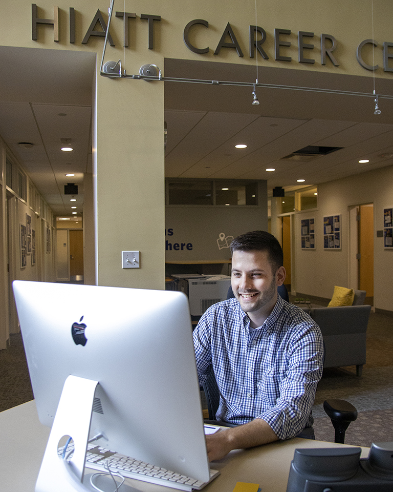 A staff member works on their computer at Hiatt's front desk.