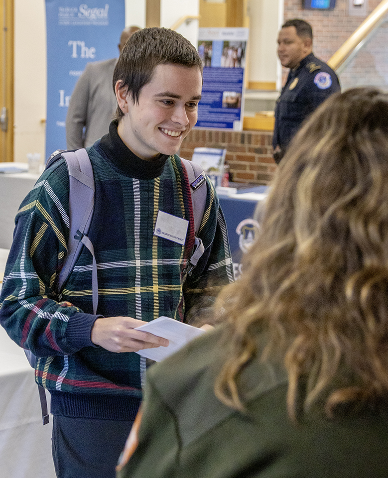 A student chats with an employer during the 2022 Government & Public Service Career Fair