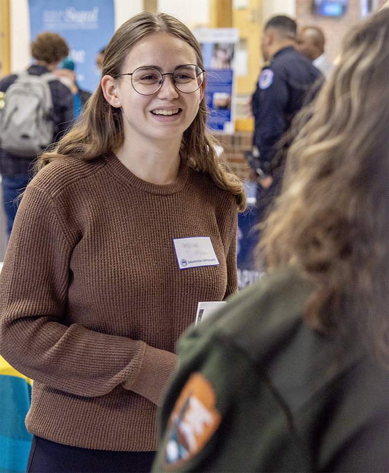 A student meets with a recruiter at a career fair.