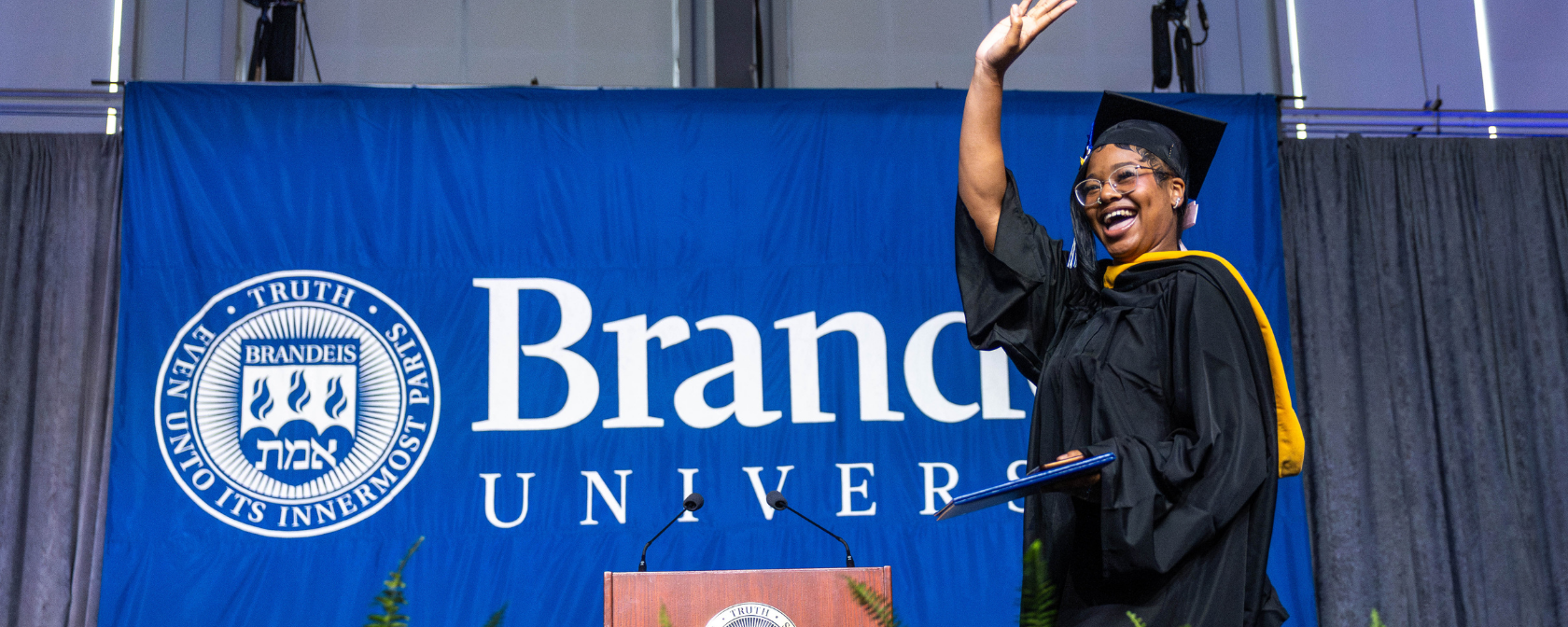 A graduate walks the stage during the 2025 undergraduate commencement at the Gosman Sports and Convocation Center on May 18, 2025.