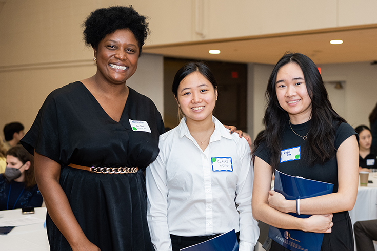 Dr. Ria Roberts '10 (left) meets with two students during Deis Dinner 2022.