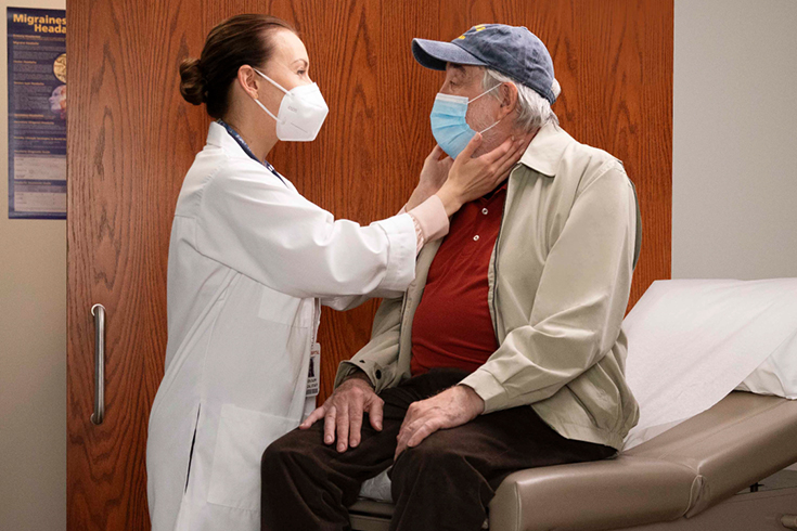  A physician assistant completes a patient checkup in a medical office.