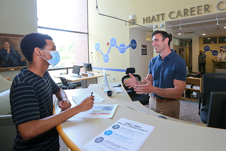 Jon Schlesinger, Director of the Hiatt Career Center, speaks with a student in the Hiatt lobby.