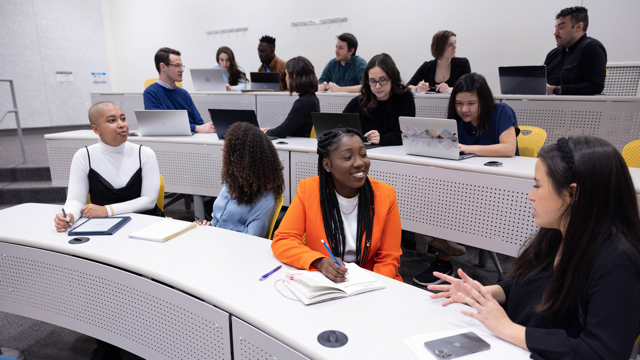 Graduate students connecting in classroom