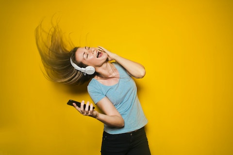 woman listening to music on headphones