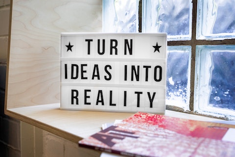 A sign that reads "turn ideas into reality"