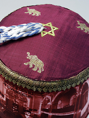 close up view of red fez cap with hassle and gold Star of David