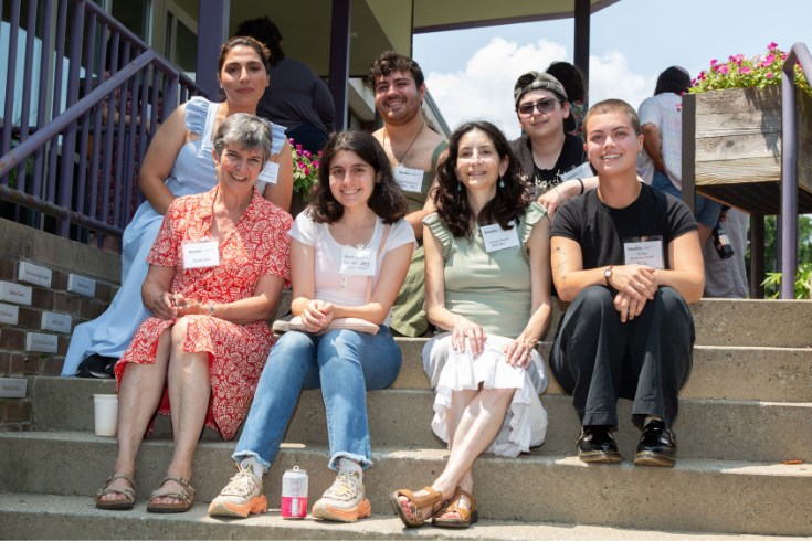 people sitting together on steps to a building