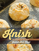 Book Cover: Knish (in 3-dimensional yellow script letters). In Search of the Jewish Soul Food.  Laura Silver.  Background photograph of a baking sheet with knishes.
