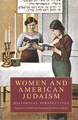 Book cover text reads: Women and American Judaism Historical Perspectives. Pamela S. Nadell and Jonathan D. Sarna, editors. Illustration is of 2 women with prayerbooks standing at the table which has candles lit.  At the top is  a box containing Yiddish text.