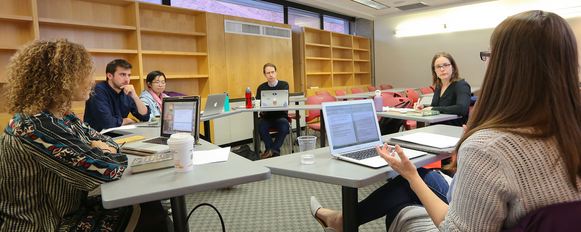 Professor Hannah Muller and students look on while another student speaks during class.