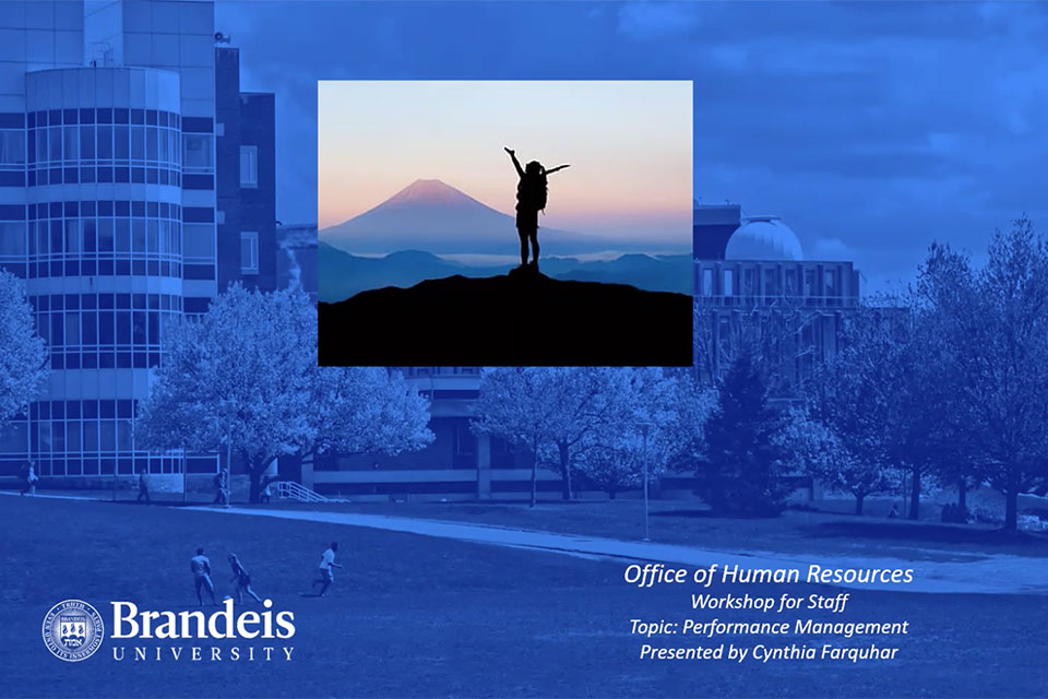 Title slide of presentation, Brandeis campus in the background with a blue overlay