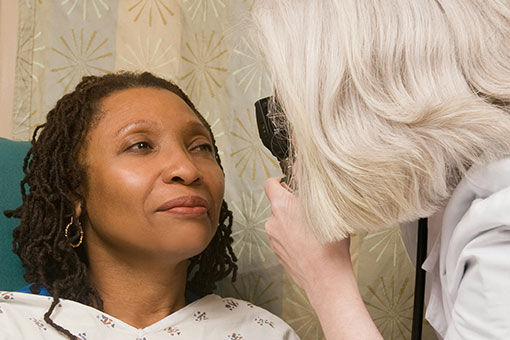A doctor examines a patient's eye