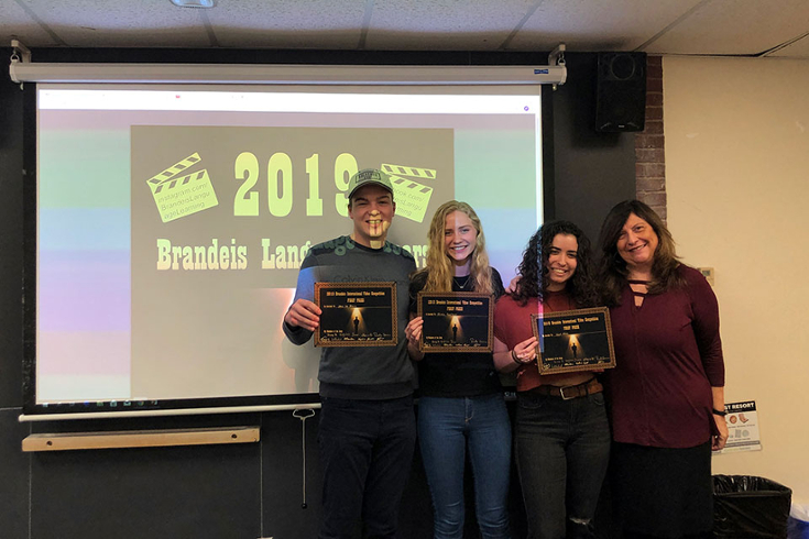 Students hold their awards for the 2019 video competition