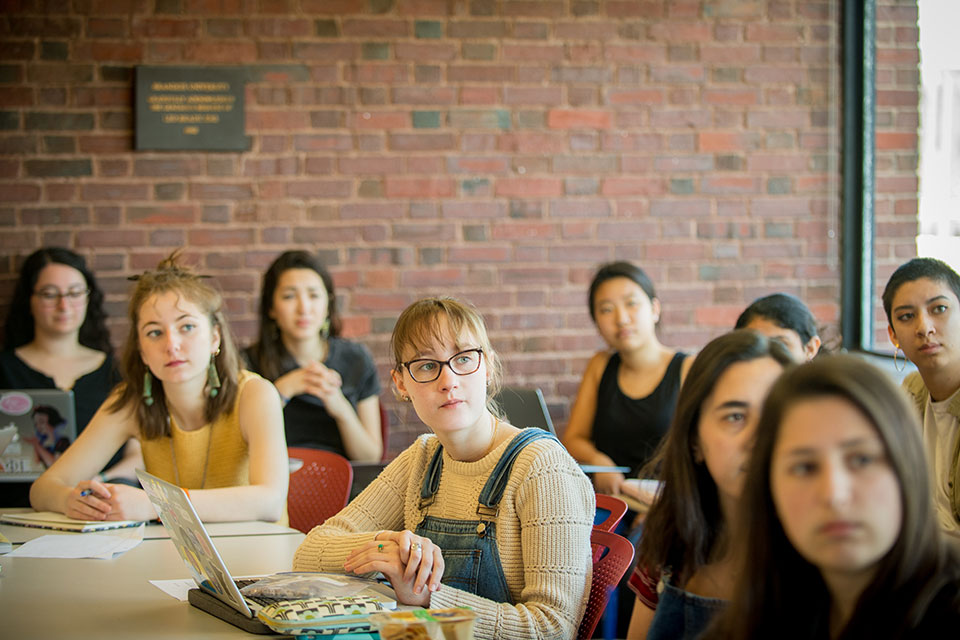 Student in a classroom look toward the front of the classroom