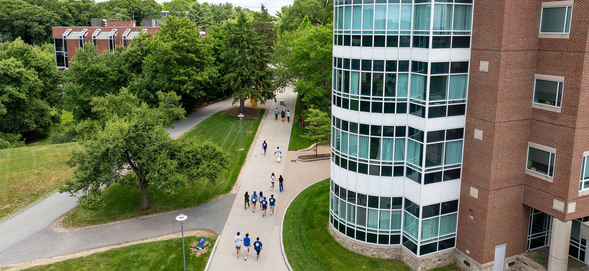 The Brandeis campus, with students walking up and down a pathway