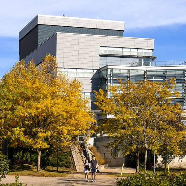 People walking near the Shapiro Science building on campus