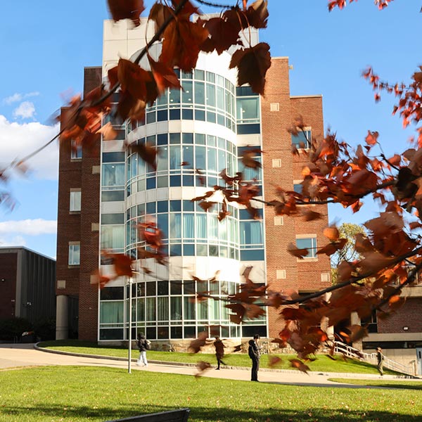 The Volen building on the Brandeis campus with fall leaves in the foreground