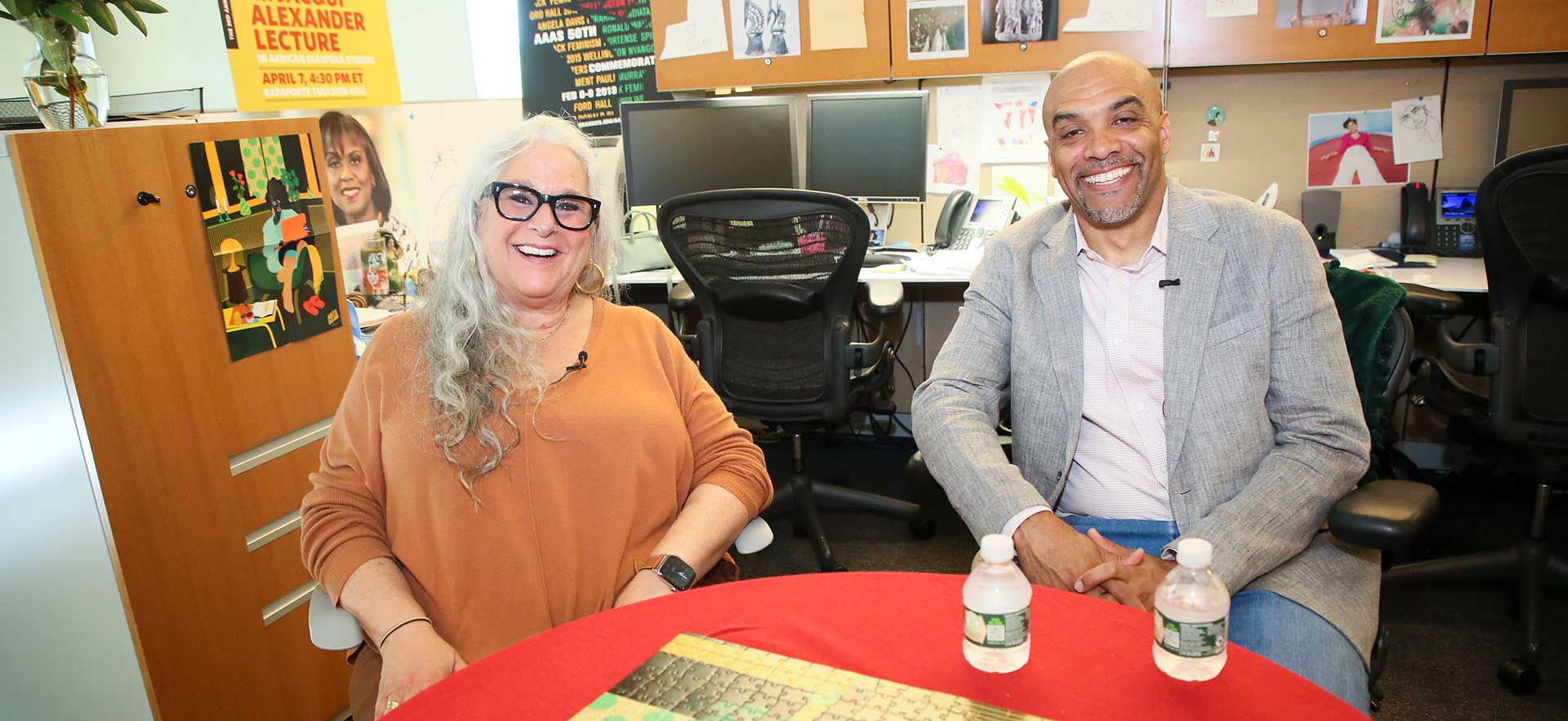 Marta Kauffman and Chad Williams sitting, laughing, at a table