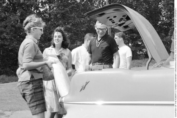 Students and parents unpacking a car