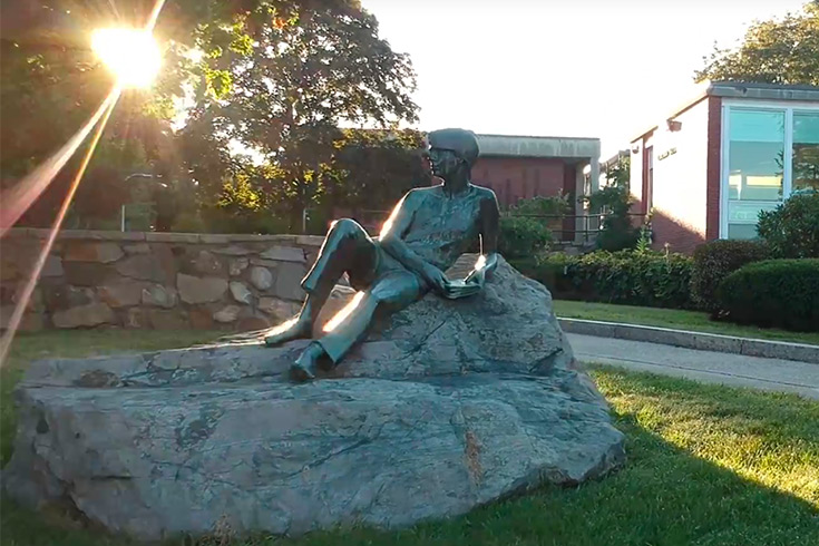 A statue in front of the Brandeis Libraries