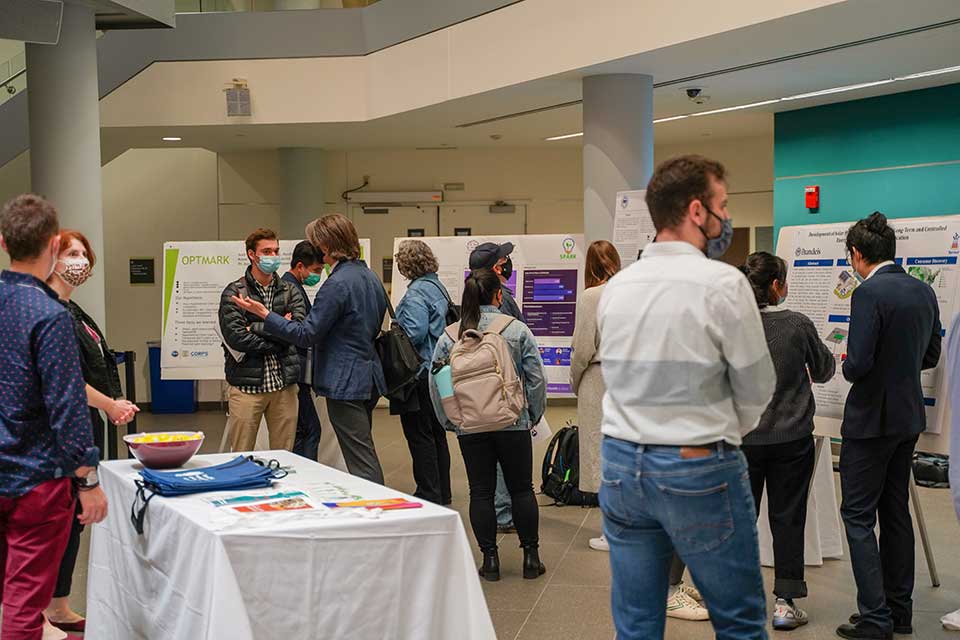 people at a networking event with posters