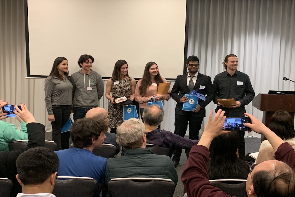 Popular vote winners stand together for a picture after receiving their prizes