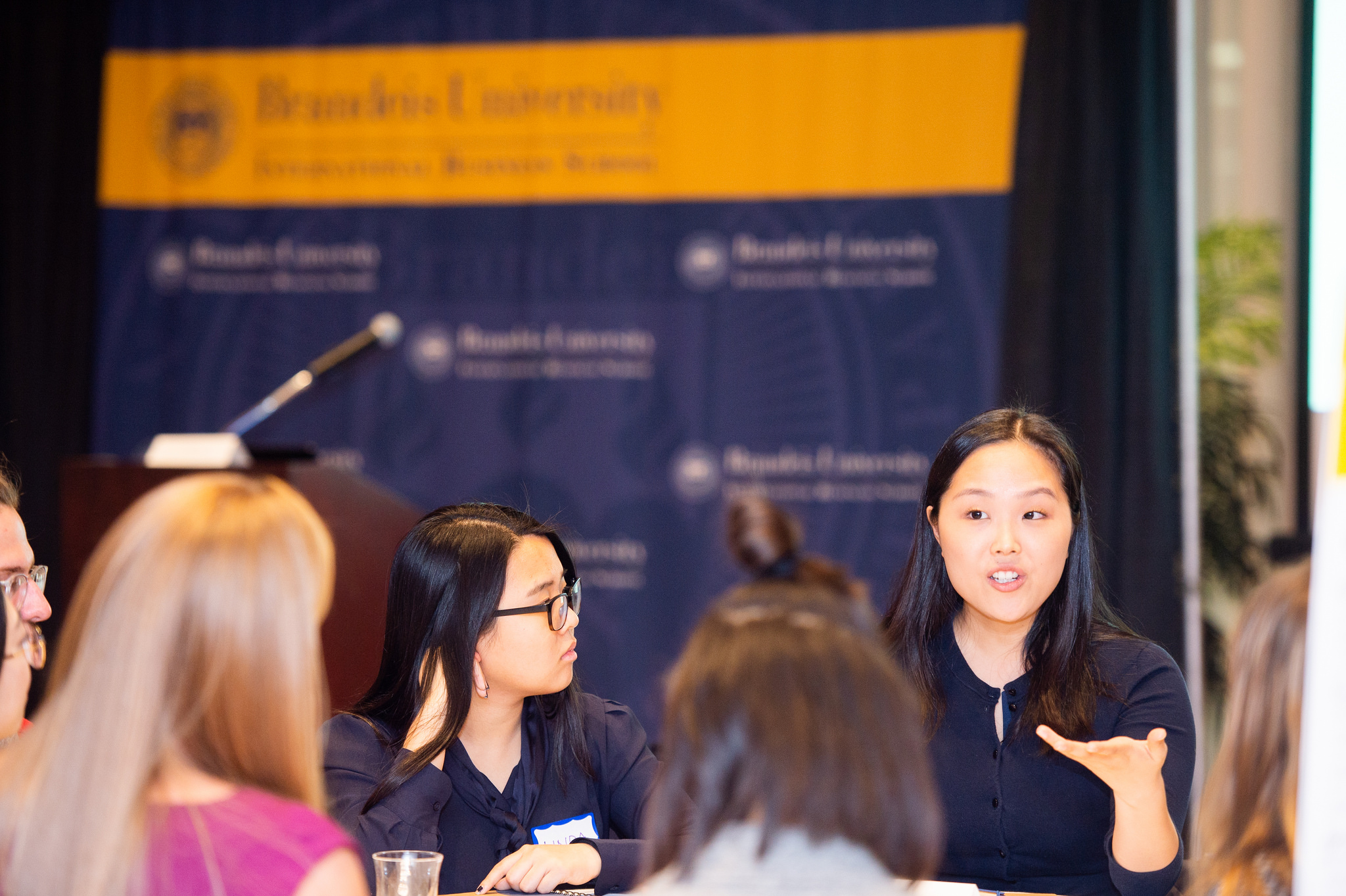 Woman speaking to group of students