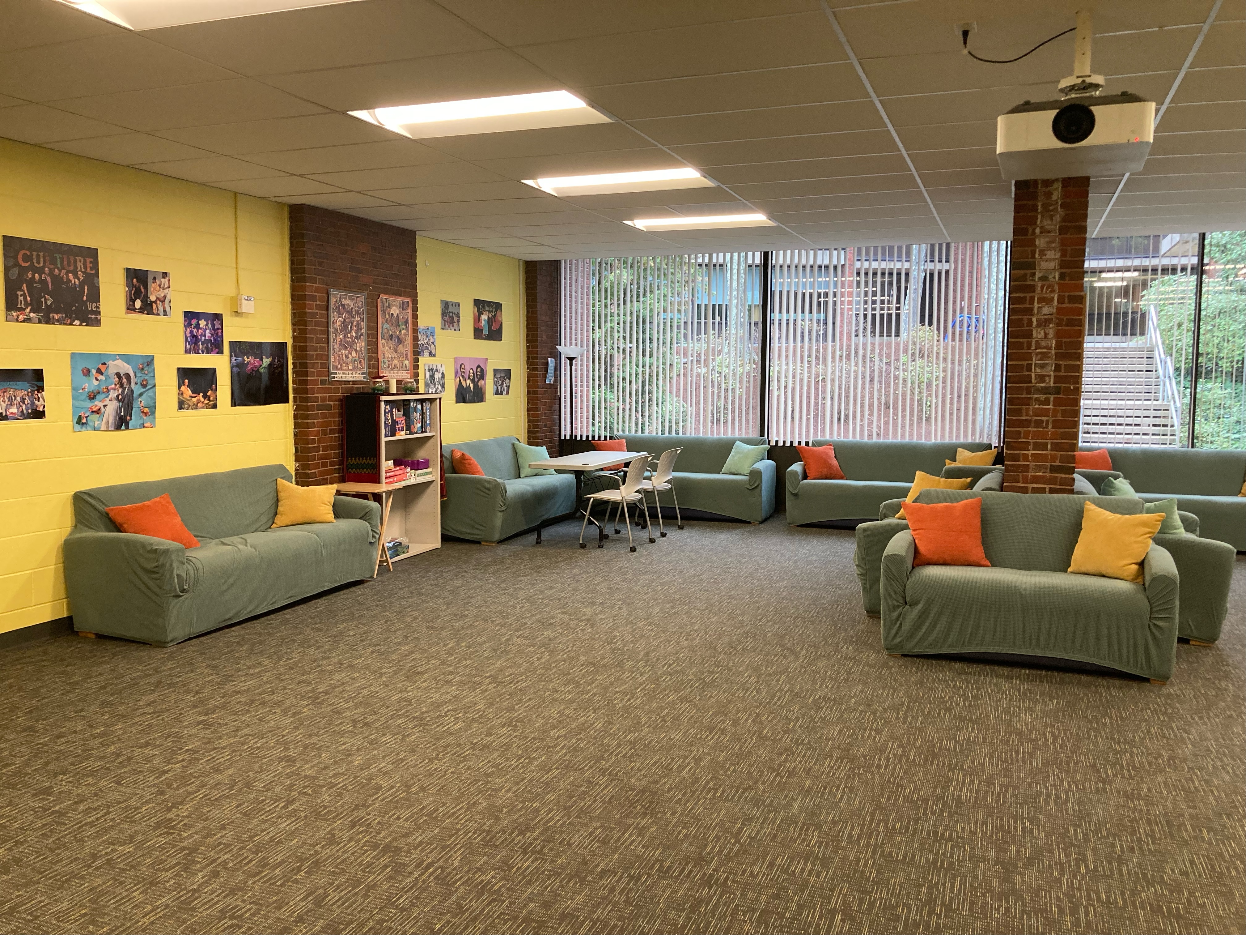 Open space with blue couches against a brick wall