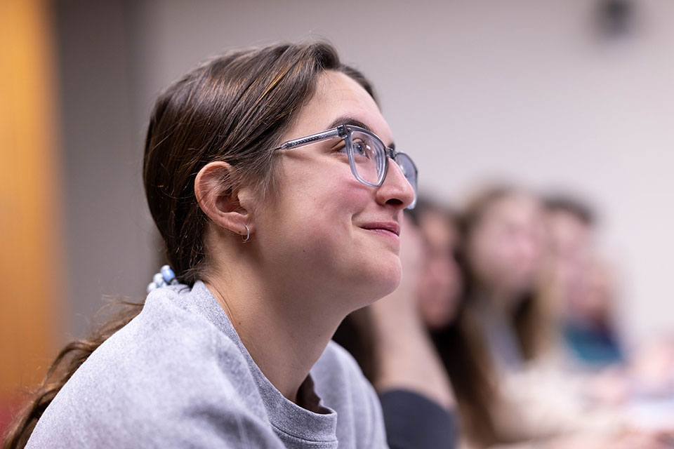 Students seated in a classroom listening to a lecture