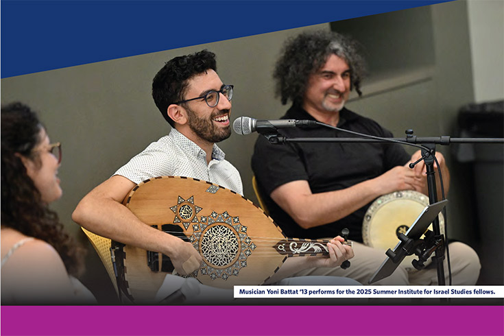 Man plays stringed instrument while a woman and man site on either side of him.