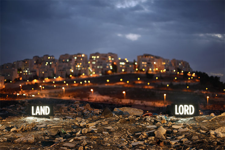 Skyline with two words Land and Lord illuminated on either side of the scene