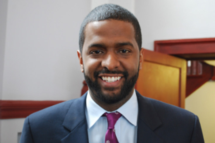 Smiling young man in a blue suit